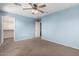 Bedroom with a ceiling fan and a view to walk-in closet and hallway at 4413 E Odessa Dr, San Tan Valley, AZ 85140