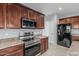 Updated kitchen with stainless steel appliances and dark wood cabinetry at 4413 E Odessa Dr, San Tan Valley, AZ 85140