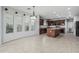 Spacious kitchen boasts dark wood cabinetry, an island, tile flooring and ample natural light at 4413 E Odessa Dr, San Tan Valley, AZ 85140