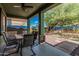 Covered patio with a dining table and seating overlooking the landscape and mini-golf in backyard at 4413 E Odessa Dr, San Tan Valley, AZ 85140
