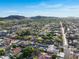 Aerial view of a vibrant neighborhood with lush greenery, mountain views and luxurious homes with private pools at 4637 W Misty Willow Ln, Glendale, AZ 85310