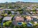 An aerial view displays the property, complemented by mature trees and a neighborhood that's close to the mountains at 4637 W Misty Willow Ln, Glendale, AZ 85310