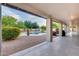 A covered patio overlooks the sparkling pool and lush landscaping at 4637 W Misty Willow Ln, Glendale, AZ 85310