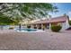 Serene backyard showcasing an inviting pool, well-manicured landscaping, and peaceful setting at 4637 W Misty Willow Ln, Glendale, AZ 85310