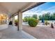 Relaxing backyard offers covered patio, sparkling pool, and meticulously landscaped grounds at 4637 W Misty Willow Ln, Glendale, AZ 85310