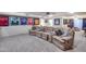 Fully finished basement with a sectional, carpeted floors, and unique sports decor at 4637 W Misty Willow Ln, Glendale, AZ 85310