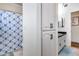 Well lit bathroom with a blue shower curtain and linen closet at 4637 W Misty Willow Ln, Glendale, AZ 85310