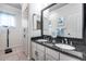 Bathroom featuring a double sink vanity with a black granite countertop at 4637 W Misty Willow Ln, Glendale, AZ 85310
