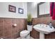 Elegant powder room with a pedestal sink and decorative tile accents at 4637 W Misty Willow Ln, Glendale, AZ 85310