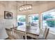 Inviting dining area with views to the pool area and decorative lighting fixture at 4637 W Misty Willow Ln, Glendale, AZ 85310