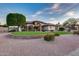 Stunning single-story home featuring meticulous landscaping, manicured lawn, and a brick-lined garden at 4637 W Misty Willow Ln, Glendale, AZ 85310