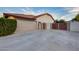 Side view of house featuring a two-car garage, and RV parking secured by wood fence at 4637 W Misty Willow Ln, Glendale, AZ 85310