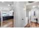 Hallway with white walls, wooden floors, white doors and trim, and view to a kitchen at 4637 W Misty Willow Ln, Glendale, AZ 85310