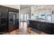 Well-designed kitchen with dark cabinets, modern appliances, and a view to the adjacent living area at 4637 W Misty Willow Ln, Glendale, AZ 85310