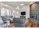 Bright living room with hardwood floors, brick fireplace, and vaulted ceilings at 4637 W Misty Willow Ln, Glendale, AZ 85310