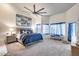 Spacious primary bedroom featuring a ceiling fan, carpet, and large windows at 4637 W Misty Willow Ln, Glendale, AZ 85310