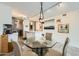 Modern dining area features a glass table, elegant seating, and artwork at 4808 N 24Th St # 1003, Phoenix, AZ 85016