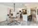 Modern dining area with glass table, stylish chairs, kitchen island, and contemporary artwork at 4808 N 24Th St # 1003, Phoenix, AZ 85016