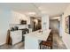 Bright kitchen with white cabinets, stainless steel appliances, island with seating, and stylish lighting at 4808 N 24Th St # 1003, Phoenix, AZ 85016