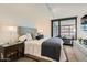 Comfortable main bedroom featuring a plush bed, stylish decor, and bright windows at 4808 N 24Th St # 1003, Phoenix, AZ 85016