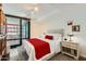 Bright main bedroom with balcony access, stylish furnishings, and a comfortable queen-sized bed at 4808 N 24Th St # 1003, Phoenix, AZ 85016