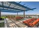 Spacious rooftop deck with lounge chairs, dining areas, pergola, turf, and panoramic city views at 4808 N 24Th St # 1003, Phoenix, AZ 85016