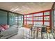 Bright sun room with large windows, dining table, comfortable seating, and tile floors at 4808 N 24Th St # 1003, Phoenix, AZ 85016
