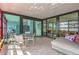 Bright sun room with floor to ceiling windows, dining table, comfortable seating, and tile floors at 4808 N 24Th St # 1003, Phoenix, AZ 85016