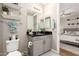 A well-lit bathroom featuring a vanity, shelving, and showing view into the bedroom at 5100 E Rancho Paloma Dr # 2065, Cave Creek, AZ 85331