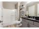 A well-lit bathroom featuring a vanity, shelving, and bath-shower combo at 5100 E Rancho Paloma Dr # 2065, Cave Creek, AZ 85331