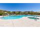 Beautiful community pool and hot tub surrounded by lush landscaping at 5100 E Rancho Paloma Dr # 2065, Cave Creek, AZ 85331