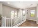 Well-lit hallway with wood floors and decorative accents, leading to other rooms in the home at 5100 E Rancho Paloma Dr # 2065, Cave Creek, AZ 85331