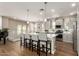 Modern kitchen featuring a large central island with seating, stainless steel appliances and pendant lights at 5100 E Rancho Paloma Dr # 2065, Cave Creek, AZ 85331