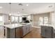 Open concept kitchen with a large island, stainless steel appliances, and a view of the living room at 5100 E Rancho Paloma Dr # 2065, Cave Creek, AZ 85331