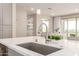Close-up of a stainless steel faucet and sink and white quartz countertops in a modern kitchen at 5100 E Rancho Paloma Dr # 2065, Cave Creek, AZ 85331
