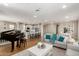 Open-concept living space featuring hardwood floors, a piano, and seamless flow to the kitchen at 5100 E Rancho Paloma Dr # 2065, Cave Creek, AZ 85331