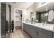 A sleek bathroom featuring double sinks, granite countertops and a glass-enclosed shower at 5100 E Rancho Paloma Dr # 2065, Cave Creek, AZ 85331