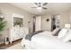 A well-lit main bedroom featuring a white dresser and comfortable king-size bed with bright white bedding at 5100 E Rancho Paloma Dr # 2065, Cave Creek, AZ 85331