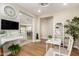 Stylish office with a view of the kitchen featuring hardwood floors and a glass desk at 5100 E Rancho Paloma Dr # 2065, Cave Creek, AZ 85331