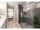 Modern bathroom shower featuring large tile, glass door and leafy green accent with a view into the bedroom at 5100 E Rancho Paloma Dr # 2065, Cave Creek, AZ 85331