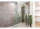Modern bathroom shower featuring large tile, glass door and leafy green accent at 5100 E Rancho Paloma Dr # 2065, Cave Creek, AZ 85331