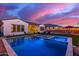 Inviting backyard showcasing pool and spa, lounge chairs, well-manicured lawn, and sunset views at 5228 S 106Th Pl, Mesa, AZ 85212