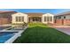 Expansive backyard with a pool, lush lawn, outdoor seating, and a covered patio, ideal for entertainment and relaxation at 5228 S 106Th Pl, Mesa, AZ 85212