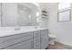 Bathroom with dual vanities, modern lighting, and a glass-enclosed shower at 5228 S 106Th Pl, Mesa, AZ 85212