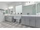 Bathroom featuring dual vanities, decorative tile flooring, and modern fixtures at 5228 S 106Th Pl, Mesa, AZ 85212