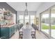 Elegant dining room with stylish light fixture, seating for ten, and custom bar at 5228 S 106Th Pl, Mesa, AZ 85212