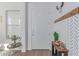 Bright entryway features a white door, stylish console table, modern decor, and hardwood floors at 5228 S 106Th Pl, Mesa, AZ 85212