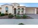 Charming home exterior features arched entryway, desert landscaping, and a well-maintained front yard at 5228 S 106Th Pl, Mesa, AZ 85212