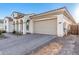 Home exterior showcases a spacious two-car garage and brick driveway with a stucco facade at 5228 S 106Th Pl, Mesa, AZ 85212