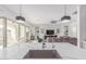 Open-concept kitchen with large island and sink overlooking the living room and outdoor patio at 5228 S 106Th Pl, Mesa, AZ 85212